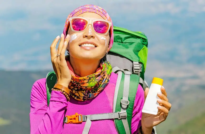 Applying sun protection as a part of makeup while camping